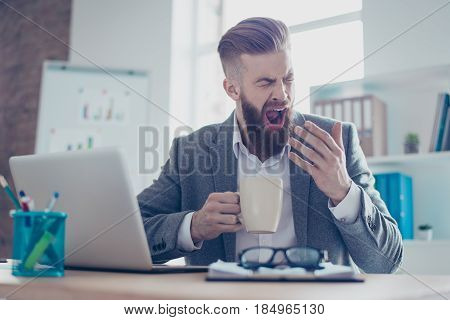 Portrait Of A Sleepy Tired Businessman Snoozing And Having A Coffee At The Work Place