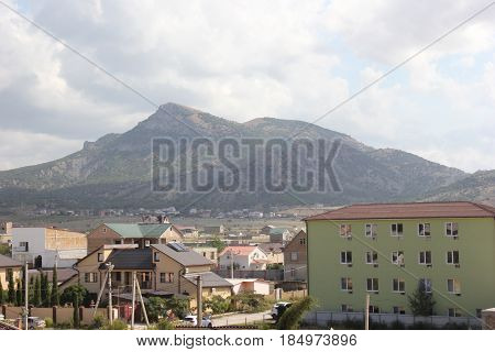 Russia. Crimea for travelers. Landscape blue sky with clouds, mountains, residential buildings