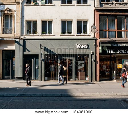 STRASBOURG FRANCE - APR 27 2017: Pedestrians walking in front of the Vans in France - Vans is an American manufacturer of shoes based in Cypress California owned by VF Corporation