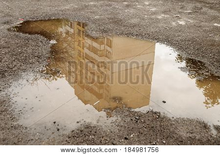 Reflection In Large Puddle On An Overcast Day