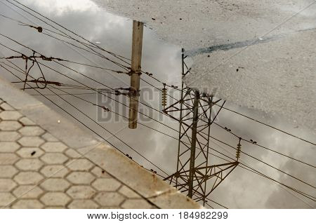 Reflection In Large Puddle On An Overcast Day