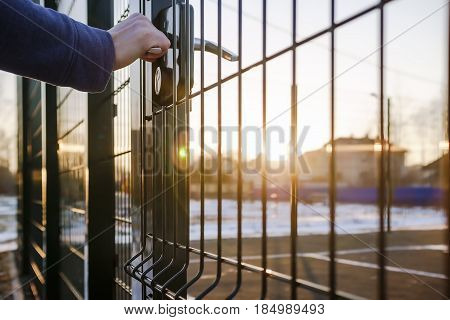 person wants get in on playground through the little gate of the welded wire mesh wonderful winter sunny day