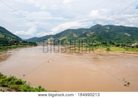 Natural landscape of Mekong River is a muddy color flowing through the mountains is the border between Thailand and Laos photo is taken in Chiang Rai Province Thailand