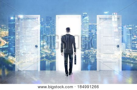 Rear view of a businessman with a suitcase is standing in front of three doors choosing one of them. 3d rendering double exposure