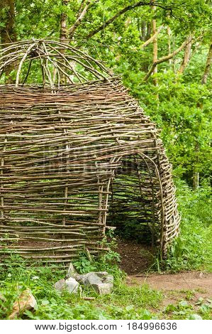 Small Cottage Made Of Wooden Sticks In Woods