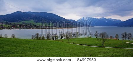 panoramic view at the tegernsee lake and the blue and snow covered mountains in the famous tourist resort Bavarian Alps Bavaria Germany Europe