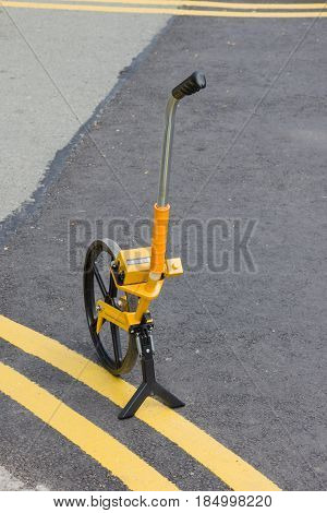 Surveyor's wheel or clickwheel used to measure distances on roads or pavements by road or utility maintenance workers