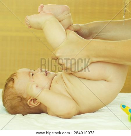 Closeup Portrait View Of One Funny Happy Smiling Cute Little Baby Boy With Blonde Hair Lying On Bed 