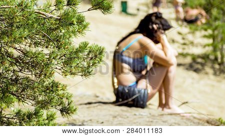 Defocused Image Of Alone Sad Stylish Woman Sitting On A Sea Beach, Talking On The Phone.  Lonely Wom