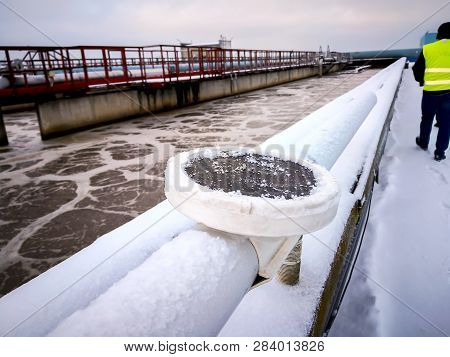 Soviet Water Treatment Plant. Workers In Yellow Vests. The Solid Contact Clarifier Tank Type Sludge 