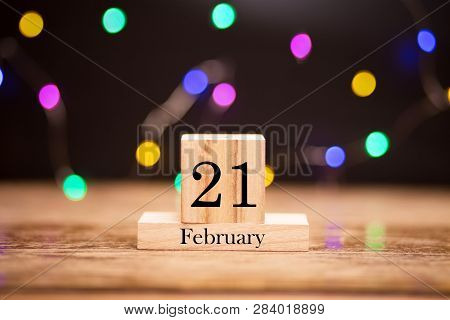 February 21th. Day 21 Of February Month Set On Wooden Calendar At Center Of Dark Background With Gar