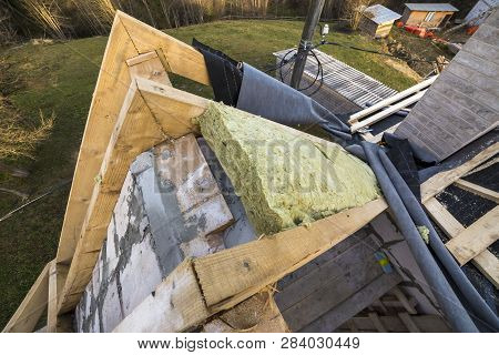 Roof Construction And Insulation With Mineral Wool. Wooden Beams Frame On Walls Of Hollow Foam Insul