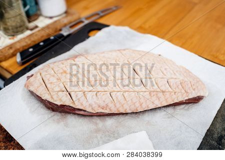 Detail Elevated View Of Kitchen Counter Table With Duck Filet Grid Cut Quadrillage On The Fat Skin -