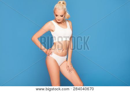Caucasian Woman With Soft And Smooth Skin Posing In White Underwear. Cream On Her Body .healthy Life