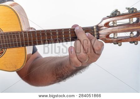 Young Man Playing Ukulele With Shirt And Black Pants.