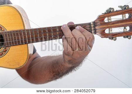 Young Man Playing Ukulele With Shirt And Black Pants.