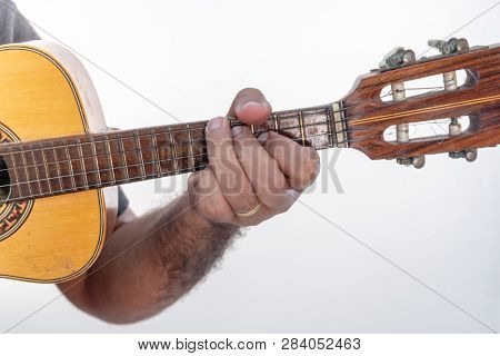 Young Man Playing Ukulele With Shirt And Black Pants.