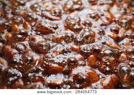 roasted almonds with cinnamon sugar cooking process, top view close-up