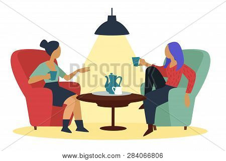 Girlfriends Talking At Cafe With Coffee Cups In Armchairs Near Table