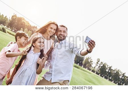 Beautiful Memories. Family Of Four Taking Selfie Photo On Smartp