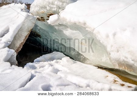 Blocks Of Ice Melt In The Spring On The Shore Of The Pond
