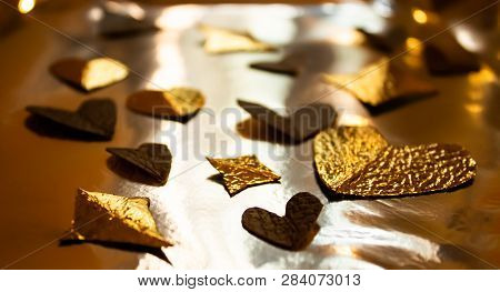 Golden Foil Hearts Decoration On The Yellow Shiny Background, Warm Glow