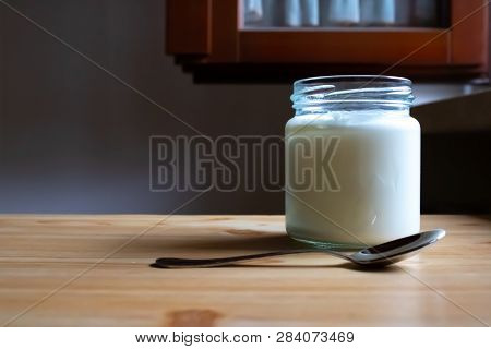 Healthy Natural Greek Yogurt On The Wooden Table With The Spoon