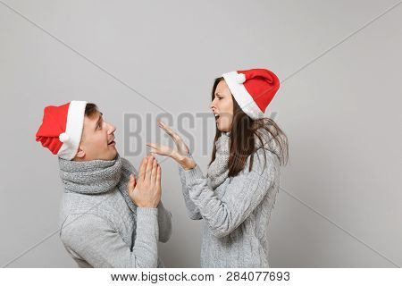 Merry Fun Couple Girl Guy In Red Santa Christmas Hat Gray Sweaters Scarves Isolated On Grey Wall Bac