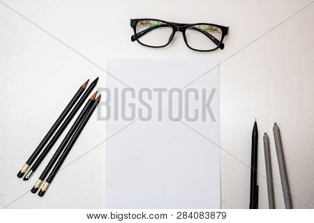 Pencils, Blank Sheet Of Paper And Glasses
