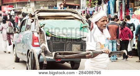 Kolkata, West Bengal, India - January 5 2019: A Rickshaw Puller Carrying A Rickshaw Also Called 
