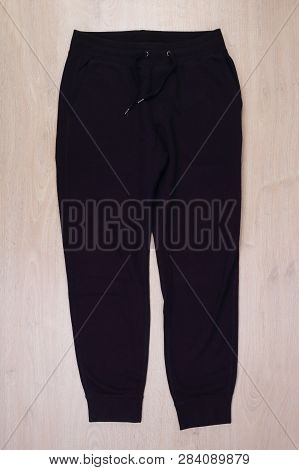 Front View Black Sweatpants On Wooden Background