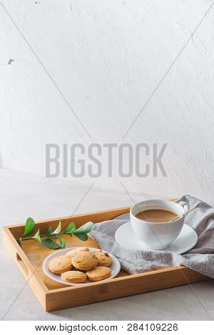Closeup Of Coffee With Milk In White Cup And Tasty Cookies. Shot On Light Stone Background