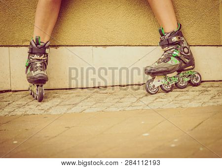Woman Wearing Roller Skates In Town. Female Being Sporty During Summer Time.