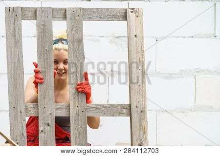 Woman Working With Pallets On Construction Site