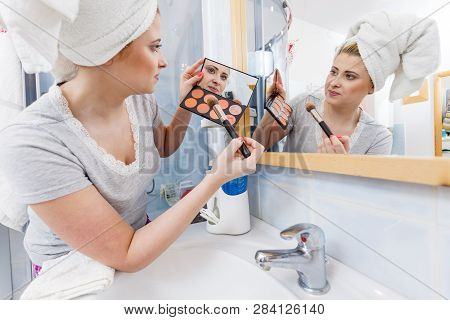 Contouring Face Kit, Visage And Make Up Concept. Woman In Bathroom Applying Contour Bronzer On Brush