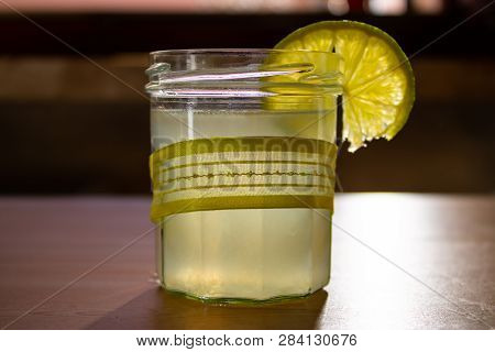 The Lime Juice In The Glass With The Piece Of Lime