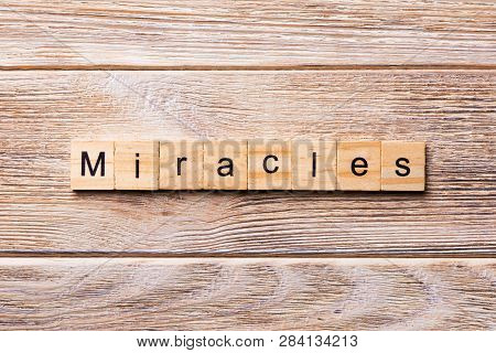 Miracles Word Written On Wood Block. Miracles Text On Wooden Table For Your Desing, Concept