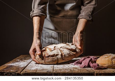 Baker Or Chef Holding Fresh Made Bread