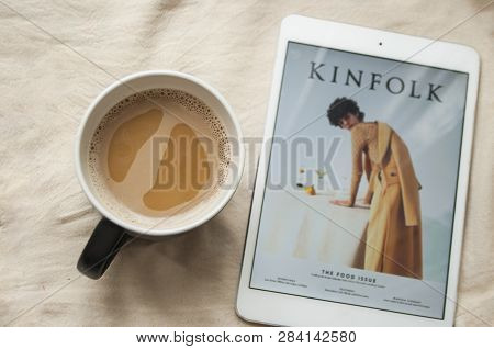 Morning Routine Concept. A Cup Of Coffee And Tablet With Kinfolk Magazine Cover.