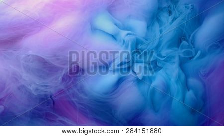 Blue Pink Clouds Of Ink In Liquid. Black Background