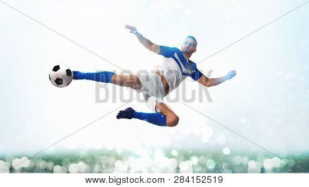 Soccer Striker Hits The Ball With An Acrobatic Kick In The Air On White Background