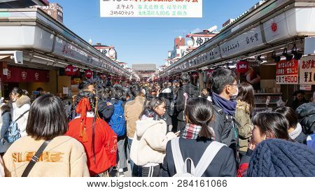 Crowds Of Tourists And Locals Walk And Shop Along Nakamise Dori Shopping Street By Sensoji Shrine In