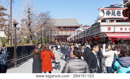 Crowds Of Tourists And Locals Walk And Shop Along Nakamise Dori Shopping Street By Sensoji Shrine In