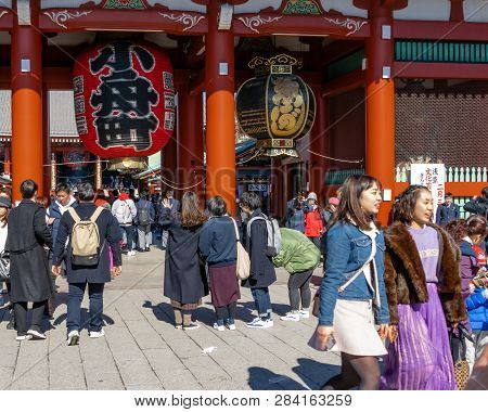 Crowds Of Tourists Visit Sensoji Temple In Asakusa Prefecture, Tokyo. Senso-ji Buddhist Temple Is De