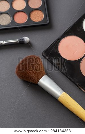 High Angle View Of An Eyeshadow Palette, Highlighter Palette, Highlighter Make Up Brush And An Eyeli
