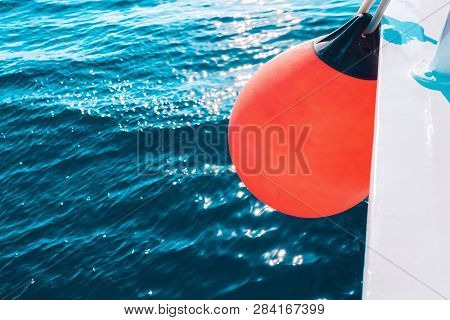 Coral Yacht Fender Against Dark Sea