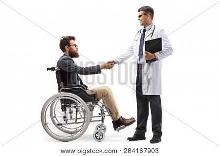 Full length shot of a man in a wheelchair shaking hands with a male doctor isolated on white background