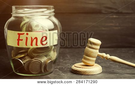Glass Jar With The Word Fine And The Judge's Hammer. Penalty As A Punishment For A Crime And Offense