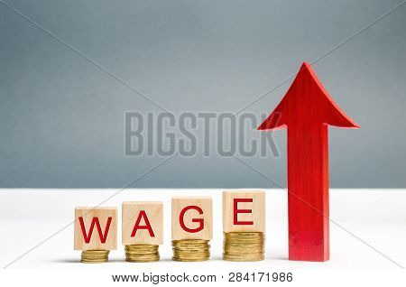 Wooden Blocks With Coins And The Word Wage And Up Arrow. Increase Of Salary. Wage Rates. Career Grow