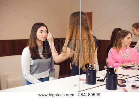 Make Up Artist Doing Professional Make Up Of Young Woman.